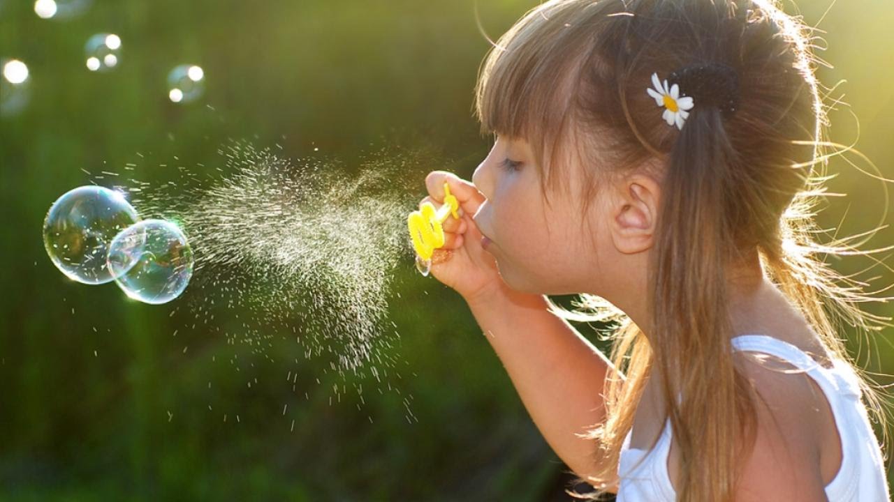 Blowing bubbles - little girl a